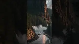 Cars Drive Through Fog and Landslide Debris on Mountain Road