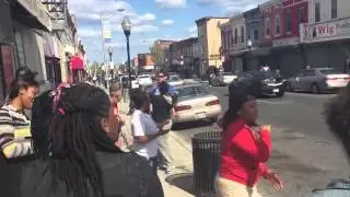Church Members Sing In Street In Baltimore Riot Aftermath