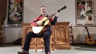 John Morran playing a song in Denholm Church @ Denholm Folkfestival 2025