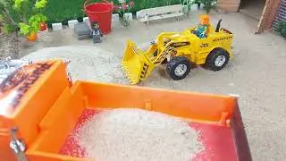 stop motion mini loader loading sand on truck