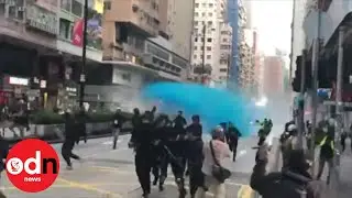 Hong Kong Police Spray Protesters With Blue-Dye Water Canons