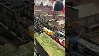 HO Scale Trains Running on a Bridge
