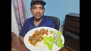Chicken Curry Cooked on a wood fire side.