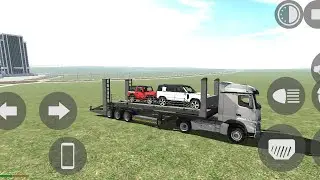 Truck driving truck loaded with thar and Defender 