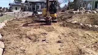 The new guy setting boulders with a mini excavator just getting creative with it.