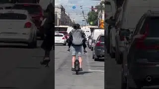 Two daredevils navigate St. Petersburg traffic on tandem one-wheel scooter