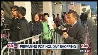 Hundreds of people prepare to shop at local retail stores