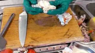 Annie shells a Spanner Crab in her kitchen at Nobby Beach