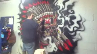 Airbrushing Indian skull mural