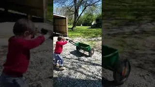 Toddler using lawn mower