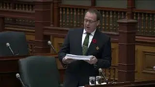 Mike Schreiner reading in a petition to increase social assistance rates