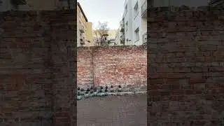 Warsaw ghetto original wall hidden between two buildings. January 2023