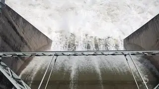 Floodwater pours through Tom Miller Dam