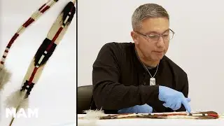 Reviewing a plume worn by a singer during the White Deerskin Dance with Alme Allen (Karuk/Yurok)