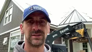 Reliable Roofer- Placing the first tapered standing seam panel