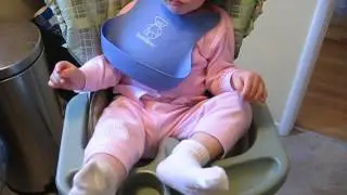 baby struggles to remove socks