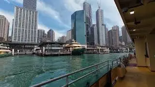 Sydney Harbour Ferries - departure Circular Quay for Manley with liner Anthem of the Seas at dock 4k