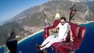 Guy Paraglides With Sofa and TV Set