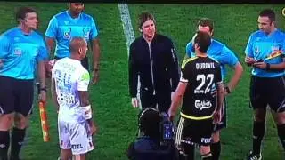Noel Gallagher flips the coin at an Australian soccer game