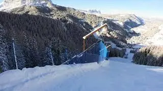 Super long and steep ski slope and following nice skier (Dolomiti, Val Gardena).