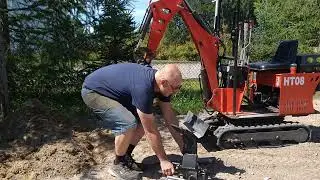 Installation d'une dent Ripper sur une HT08 et arracher une souche.