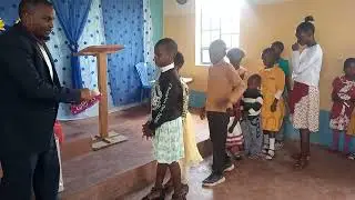 Children receiving gift chocolate from Sister vartoug