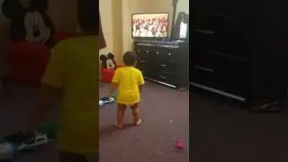 Little boy dancing to watch TV
