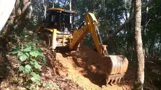 JCB constructing road in the jungle