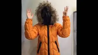 Cool girl in a yellow down jacket-space suit. Down jacket-suit with sunglasses on the hood.