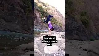 handstand attempts on a rock