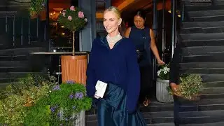 Charlize Theron is a vision in silk dress and statement necklace for rare appearance