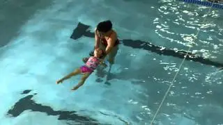 Ava floating on her back in the pool