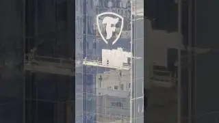 Large Firestone logo being added to the north side of Bridgestone Tower in downtown Nashville