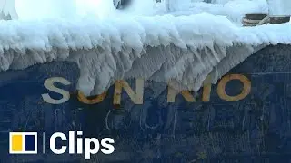 Ship from Japan arrives in Russian port covered in ice