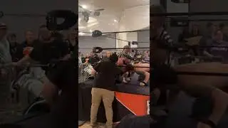 Fan jumps barricade after main event at wrestling show.