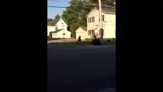 Lady Rides Bike While Holding A Baby
