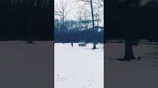 Kid pulls f250 truck backwards on snowboard