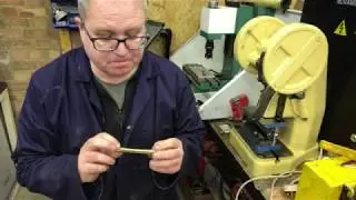 Harmonica reed blank cropping tool.
