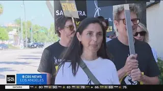 Actors continue to march as writers comb over tentative deal