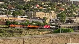 Super slow train passing under the bridge in Gallup, Nee Mexico USA