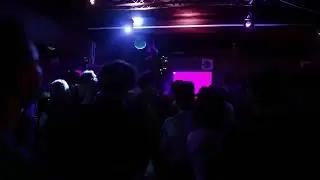crowd dancing with a disk jockeys music