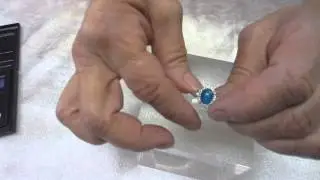 10k White Gold Ring with Blue Oval Cabochon surrounded by Melee Diamonds
