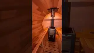 Red cedar barrel sauna with a panoramic view window