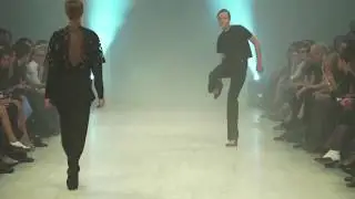 2 Models trip and remove their shoes during a 2018 fashion show
