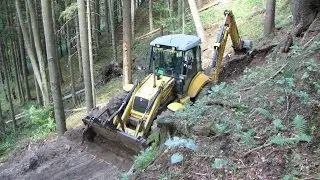 New Holland LB 115.B backhoe digging forest road II.