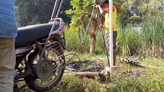 Borewell pipe lifting and drafting in bore hole new technology from motor cycle by village farmers