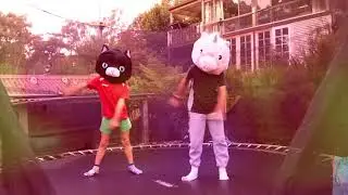 Two kids doing the Floss dance in a Unicorn and Cat mask on a trampoline - what else?!