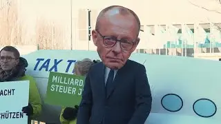 Protesters gather outside the CDU convention venue in Berlin