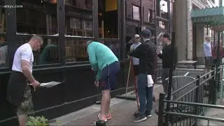 Volunteers help local business owners clean up  after Saturday's protests