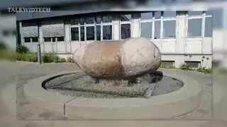 A Massive boulder slipping around on top of a Fountain